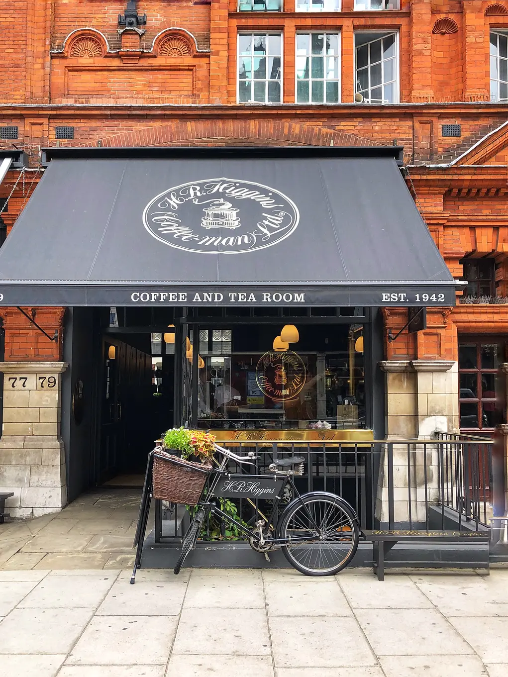 H.R. Higgins coffee and tea room shopfront in Mayfair with black awning and vintage bicycle